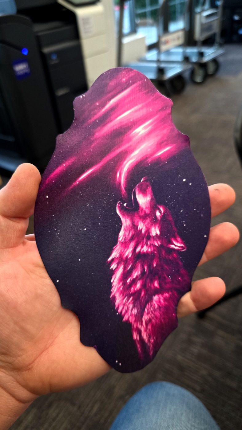 Pink wolf-shaped die-cut print on a dark purple starry background