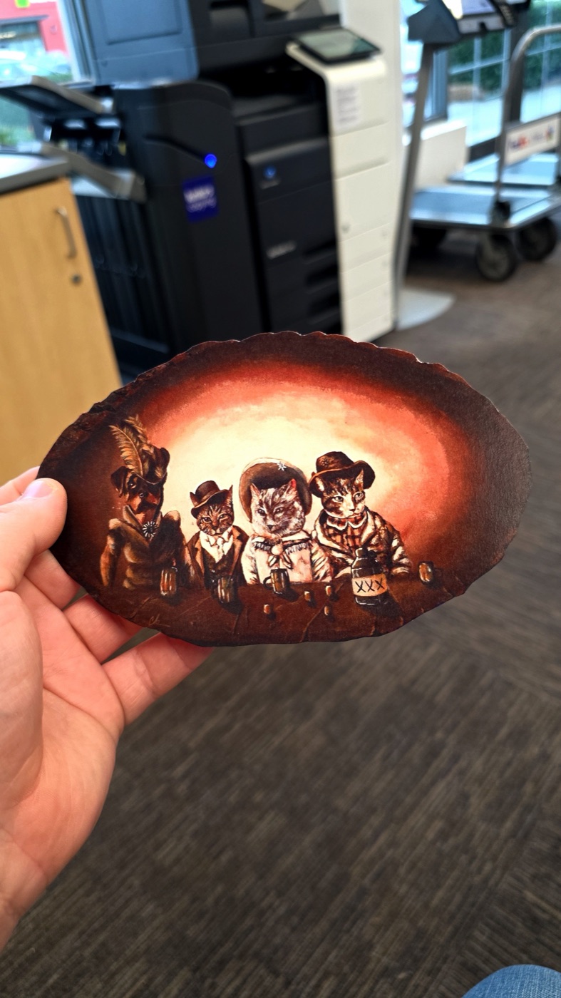 Round red-orange horror print with a group of faces near the bottom