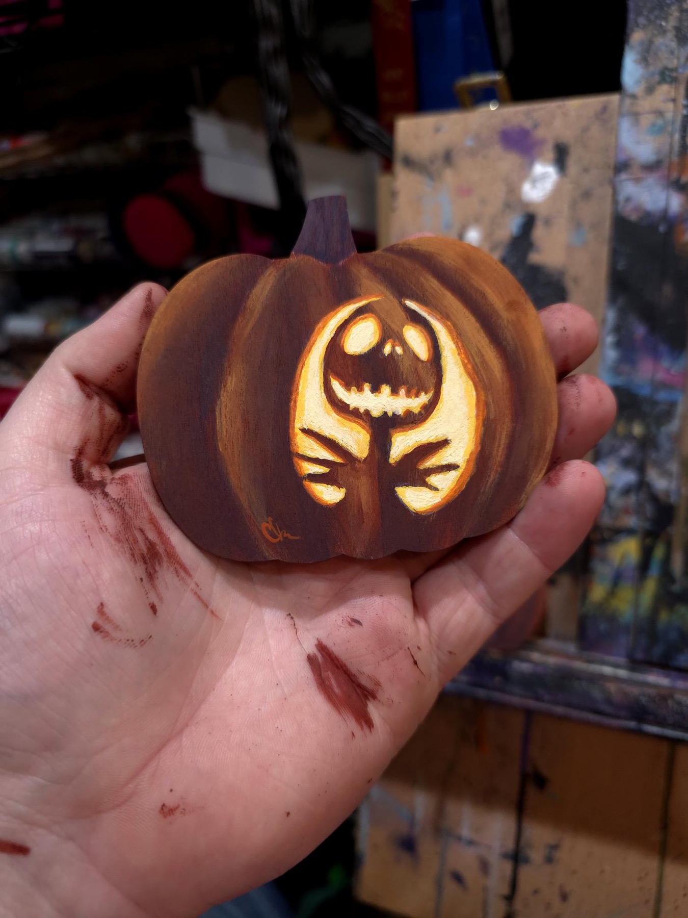 Small carved pumpkin with glowing flower-like jack face